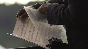 man holding music sheets